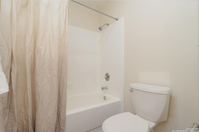 bathroom with shower / tub combo with curtain and toilet