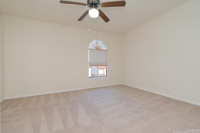 spare room featuring ceiling fan and light colored carpet