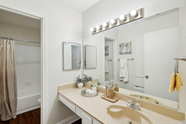 full bathroom with shower / tub combo with curtain, vanity, wood-type flooring, and toilet