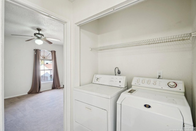 clothes washing area with separate washer and dryer, ceiling fan, light colored carpet, and a textured ceiling