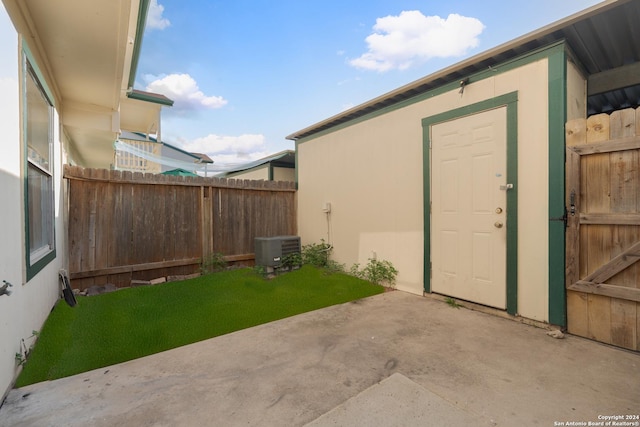 exterior space with central AC unit and a patio area