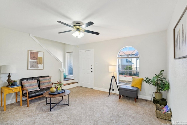 sitting room with ceiling fan and light colored carpet