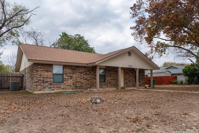 ranch-style home featuring covered porch and central AC unit