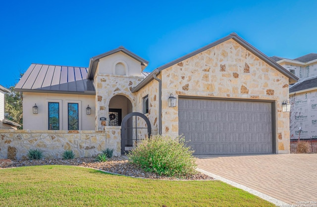 view of front facade with a front yard and a garage