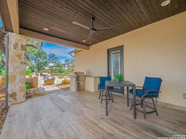 view of patio / terrace with a grill, ceiling fan, and an outdoor kitchen