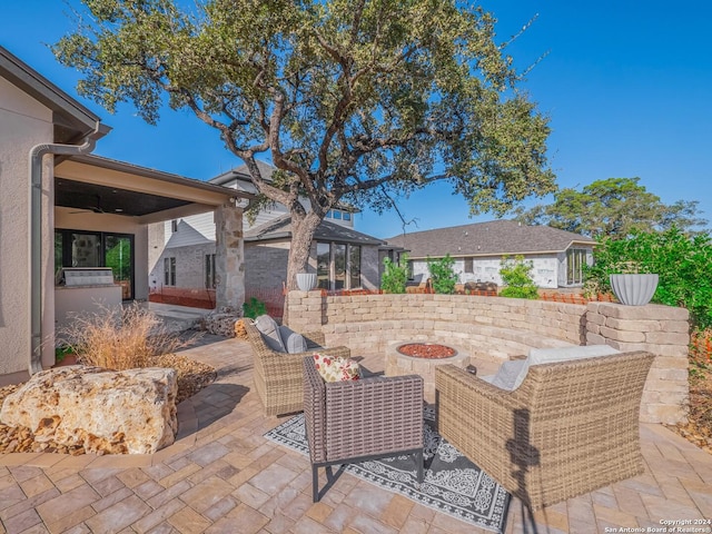 view of patio / terrace featuring an outdoor living space with a fire pit