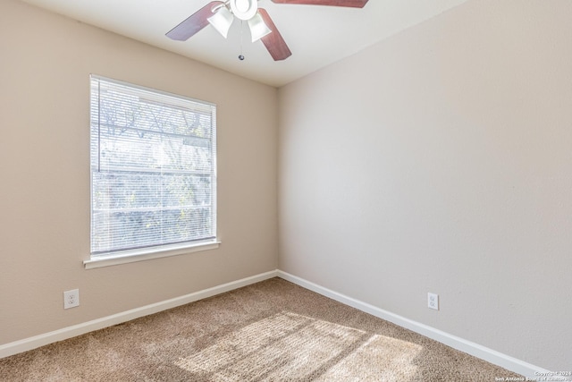 carpeted spare room featuring ceiling fan