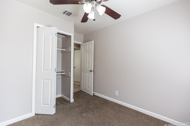 unfurnished bedroom featuring carpet, ceiling fan, and a closet