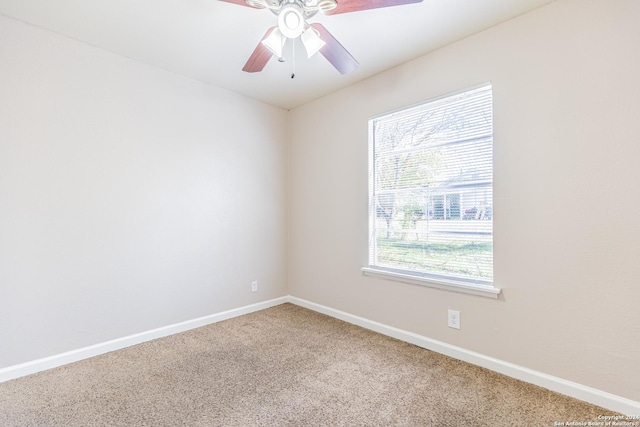 spare room featuring carpet flooring and ceiling fan