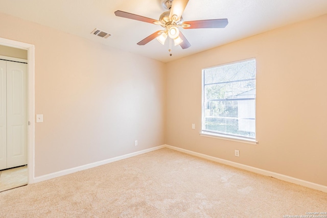 empty room featuring light carpet and ceiling fan