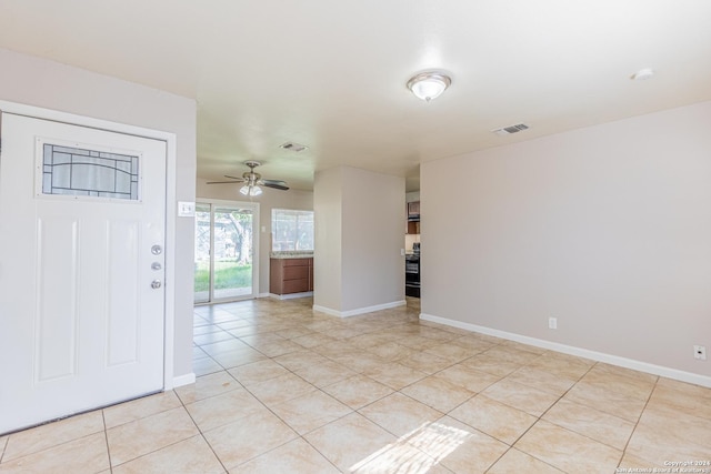 tiled foyer with ceiling fan