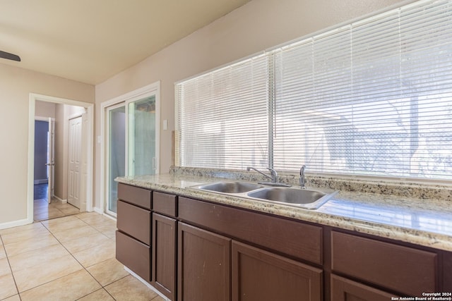 kitchen featuring light tile patterned flooring and sink