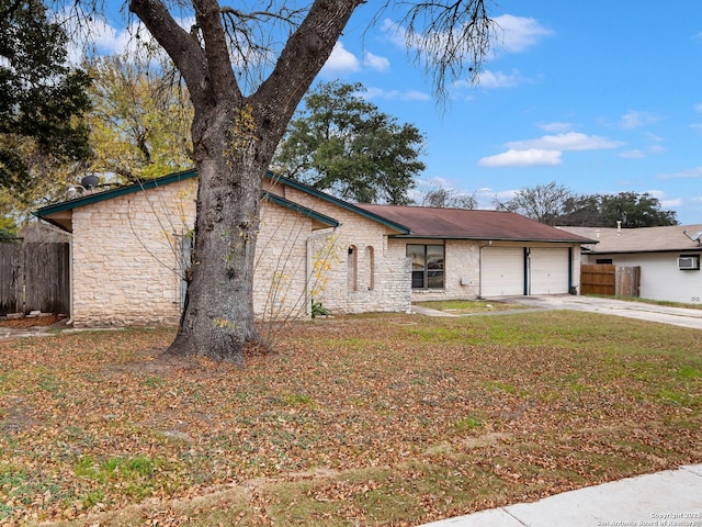 ranch-style home with a front lawn and a garage