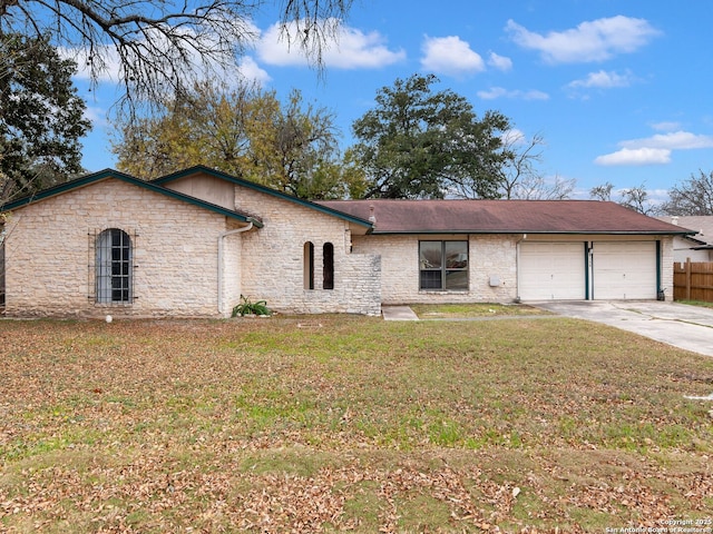 single story home with a garage and a front lawn