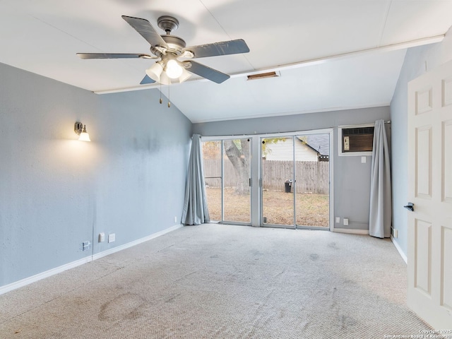 carpeted empty room featuring vaulted ceiling, ceiling fan, and a wall unit AC