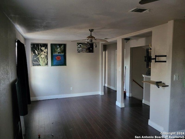 unfurnished room with ceiling fan, dark hardwood / wood-style flooring, and a textured ceiling