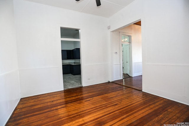 unfurnished room featuring ceiling fan and dark wood-type flooring