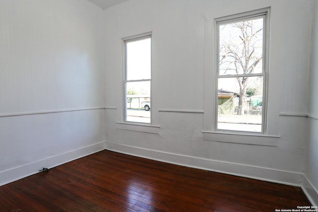 spare room featuring dark hardwood / wood-style floors