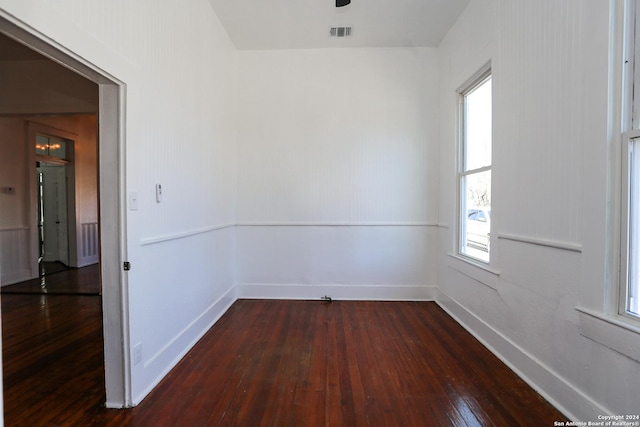 spare room featuring dark wood-type flooring