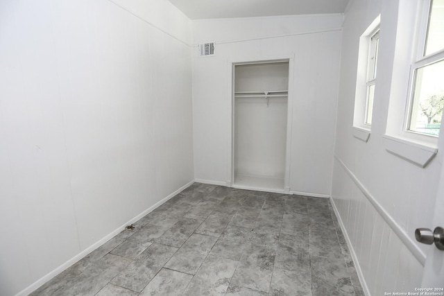 unfurnished bedroom featuring lofted ceiling