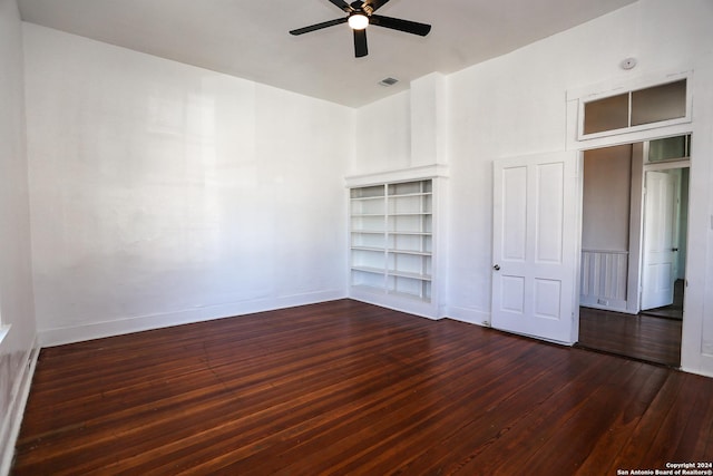 unfurnished bedroom with ceiling fan and dark wood-type flooring