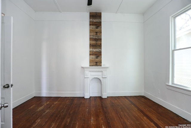 unfurnished living room with dark wood-type flooring