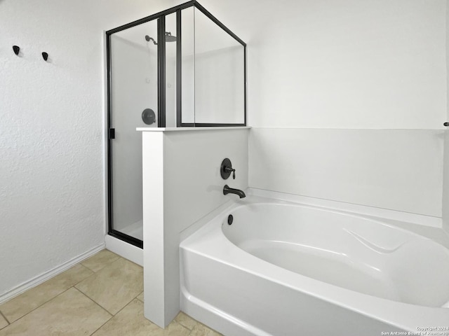 bathroom featuring a tub and tile patterned flooring