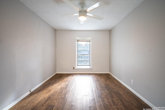 unfurnished room with ceiling fan, dark hardwood / wood-style flooring, and a textured ceiling