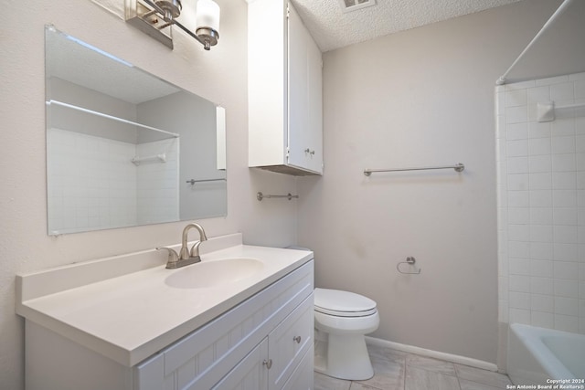 full bathroom with tile patterned floors, a textured ceiling, toilet, vanity, and bathtub / shower combination