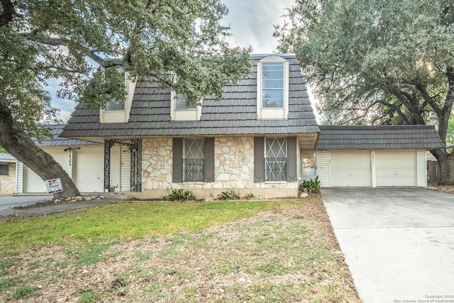 view of front of home with a front lawn and a garage