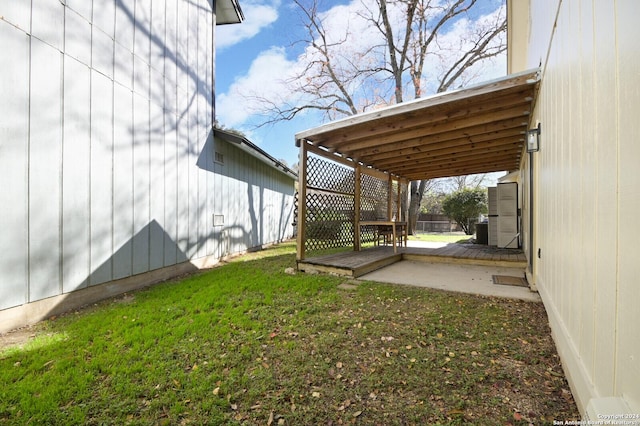 view of yard featuring a storage unit, a patio area, and central AC