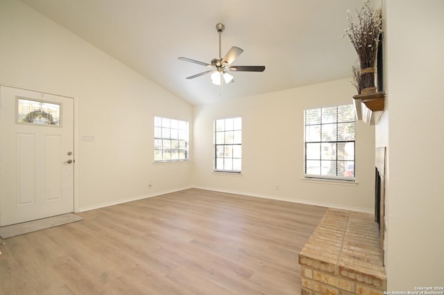 foyer entrance featuring ceiling fan, lofted ceiling, and light hardwood / wood-style flooring