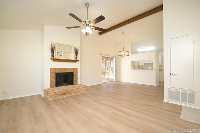 unfurnished living room featuring beam ceiling, ceiling fan with notable chandelier, light hardwood / wood-style floors, and high vaulted ceiling