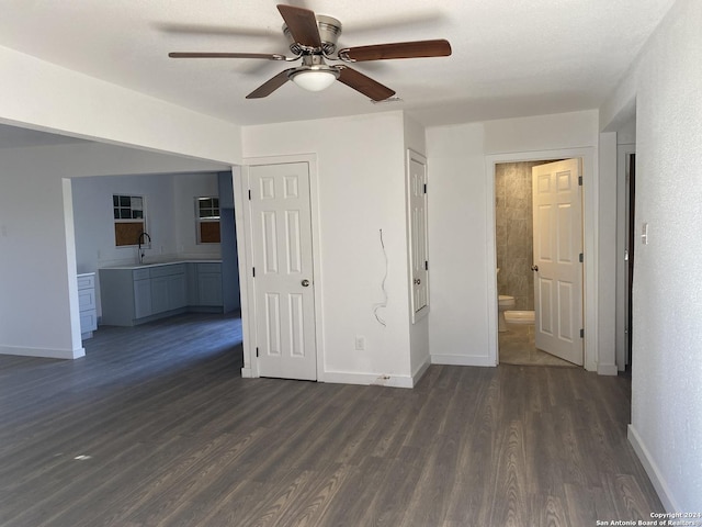 empty room with dark hardwood / wood-style floors and ceiling fan