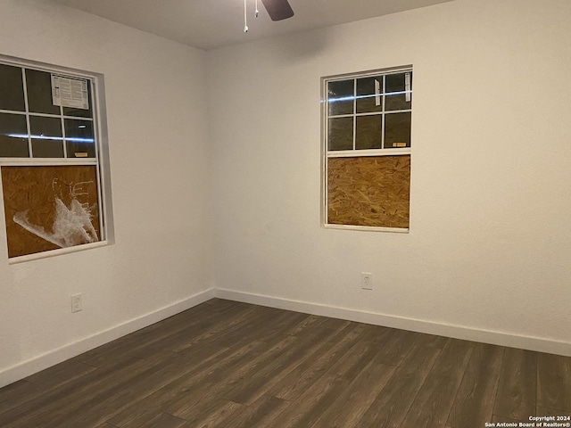 unfurnished room with dark hardwood / wood-style floors and ceiling fan