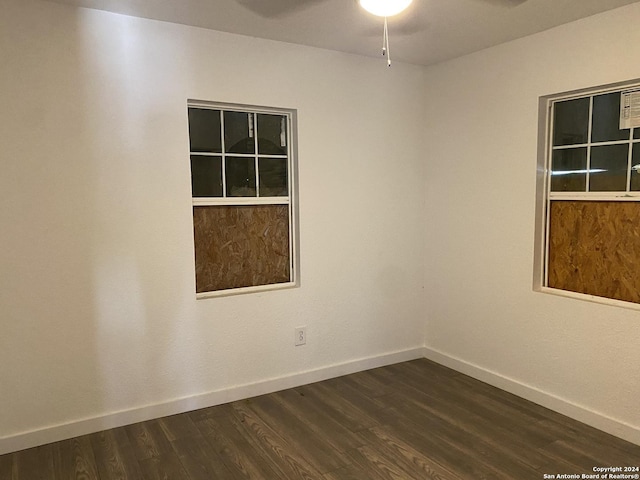 unfurnished room featuring dark hardwood / wood-style floors and ceiling fan