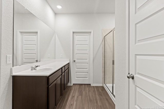 2659 Greenwell Ln, New Braunfels, TX 78130 - full bathroom featuring vanity, a shower stall, and wood finished floors
