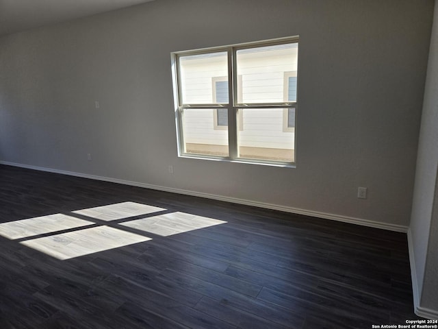 unfurnished room with dark hardwood / wood-style floors