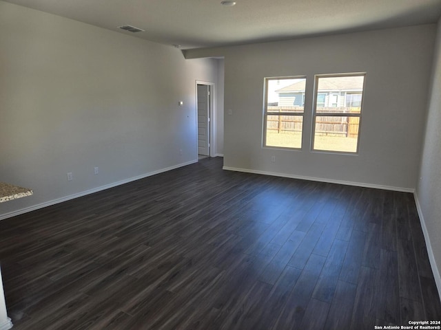 unfurnished room with dark hardwood / wood-style floors