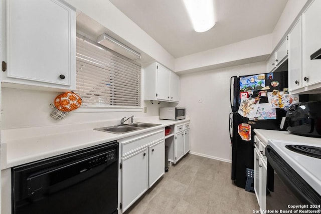 kitchen featuring sink, white cabinets, and black appliances