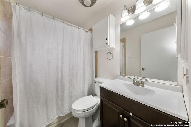 bathroom with vanity, toilet, and walk in shower