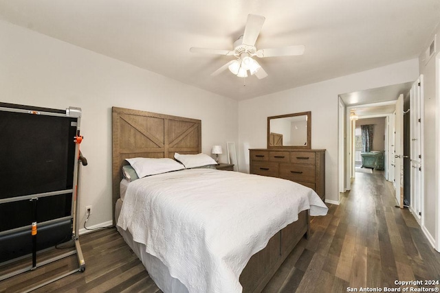 bedroom with ceiling fan and dark hardwood / wood-style flooring