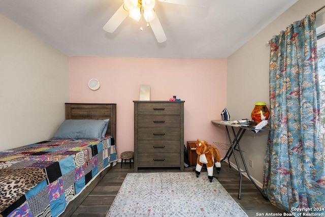 bedroom with dark hardwood / wood-style flooring and ceiling fan