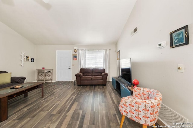 living room with dark hardwood / wood-style floors and lofted ceiling