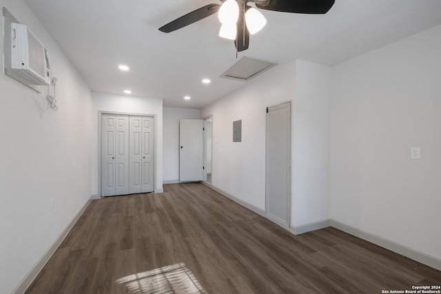 corridor featuring dark hardwood / wood-style flooring, electric panel, and a wall mounted AC