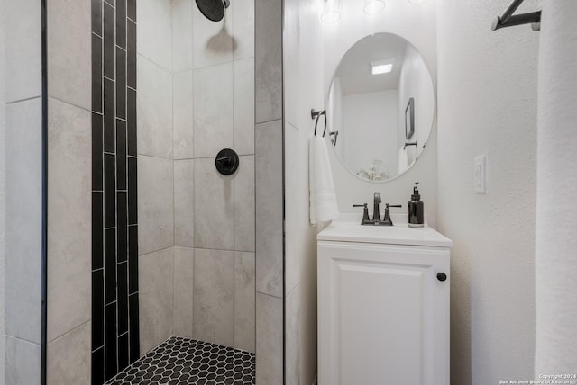 bathroom featuring vanity and tiled shower