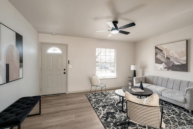 living room with ceiling fan and light wood-type flooring