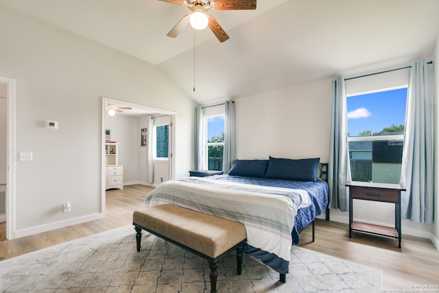 bedroom featuring ceiling fan, light hardwood / wood-style floors, and vaulted ceiling