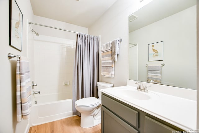 full bathroom with toilet, hardwood / wood-style floors, vanity, and shower / tub combo with curtain