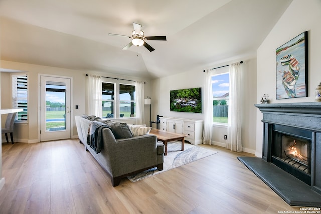 living room featuring light hardwood / wood-style flooring, ceiling fan, and lofted ceiling